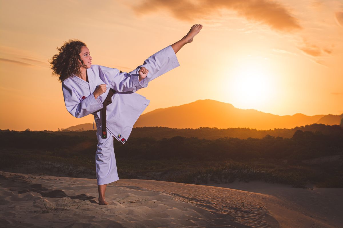 Female martial artist kicking